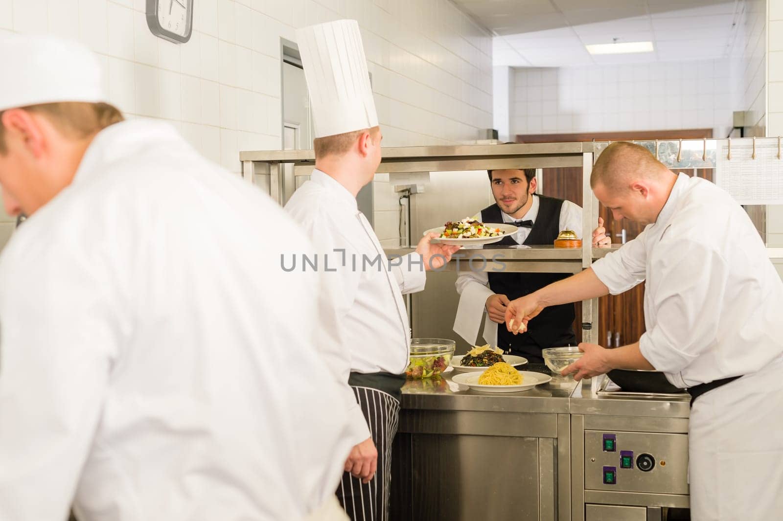 Professional kitchen cook prepare food service give meals to waiter