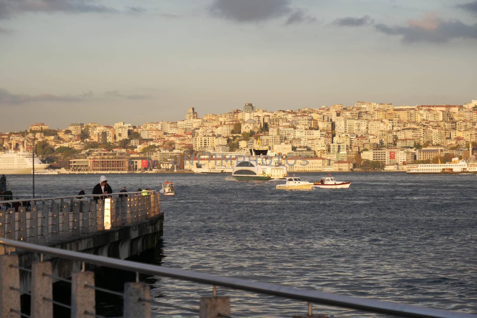 A vibrant view of Istanbul skyline with boats navigating the water.