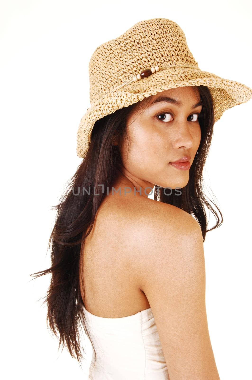 A young pretty Asian woman wearing a beige straw hat and a shoulder  free top, with long brunette hair, for white background.