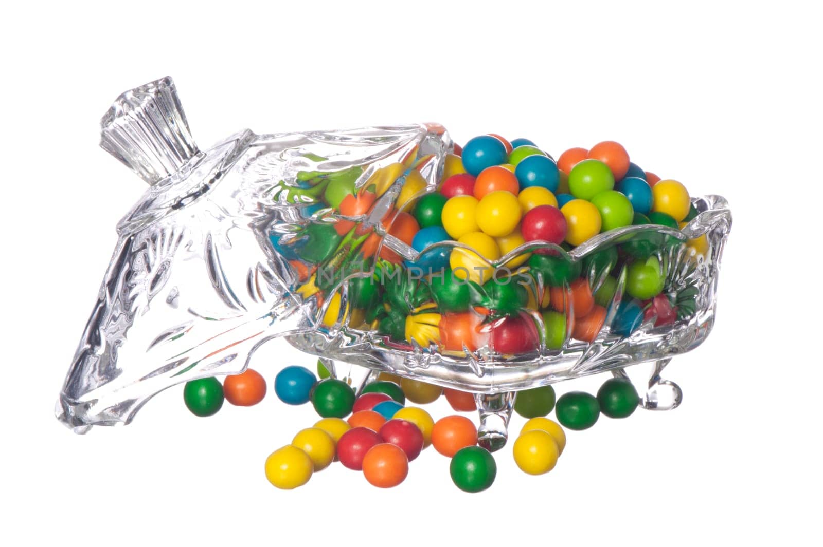 colored candy in a container of crystal on a white background