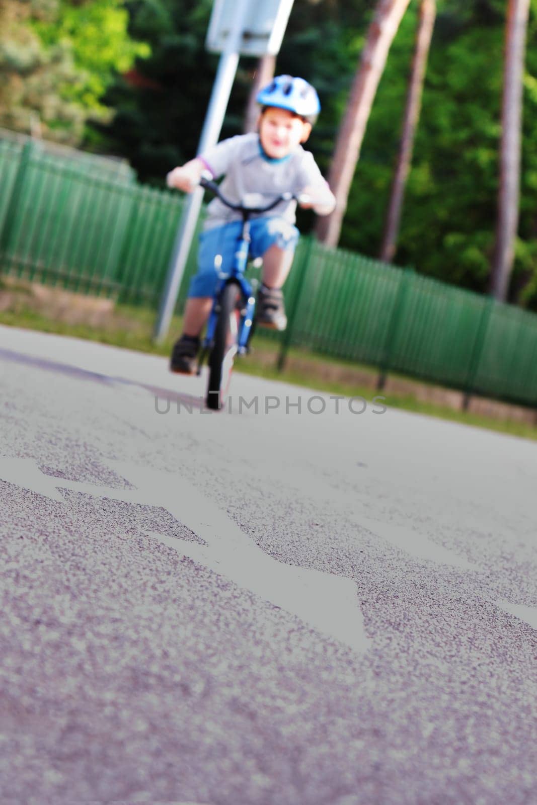 Baby boy on traffic playground for childs with crash helmet