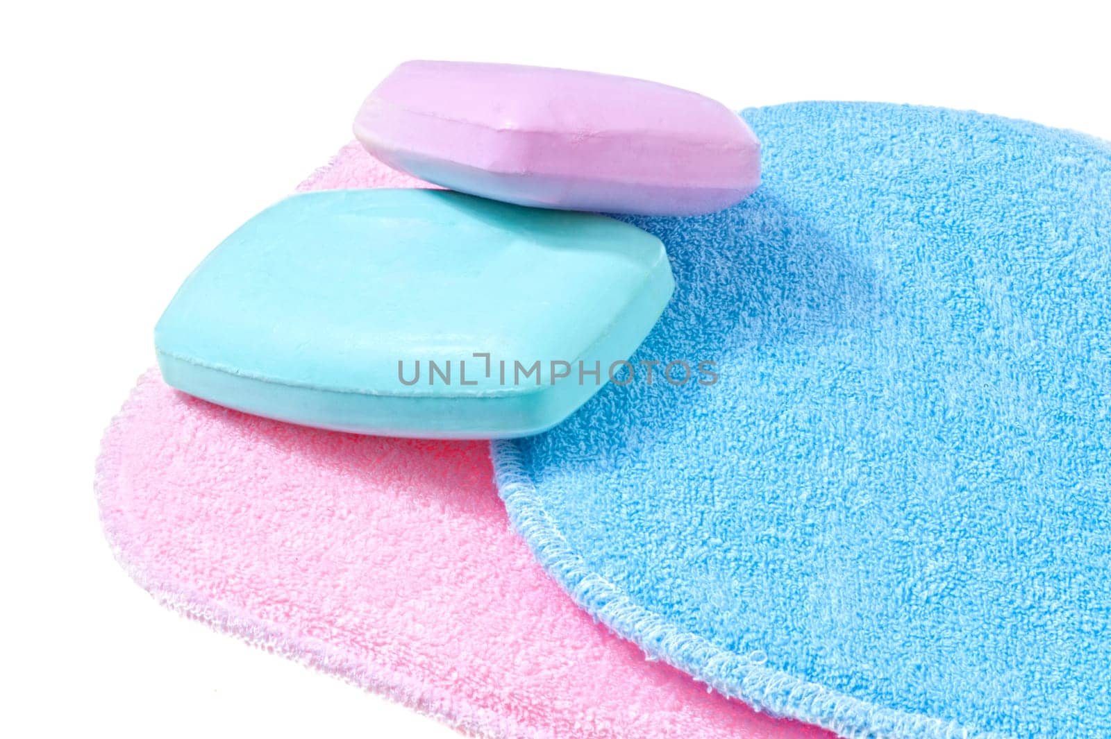 bath sponges in three different colors on white background