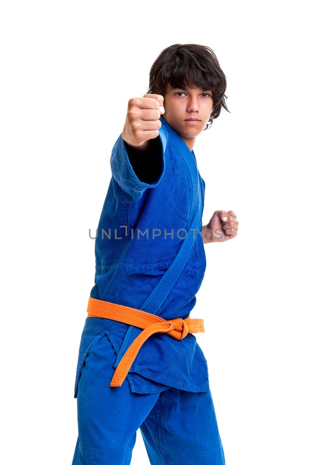 Young fighter posing against a white background