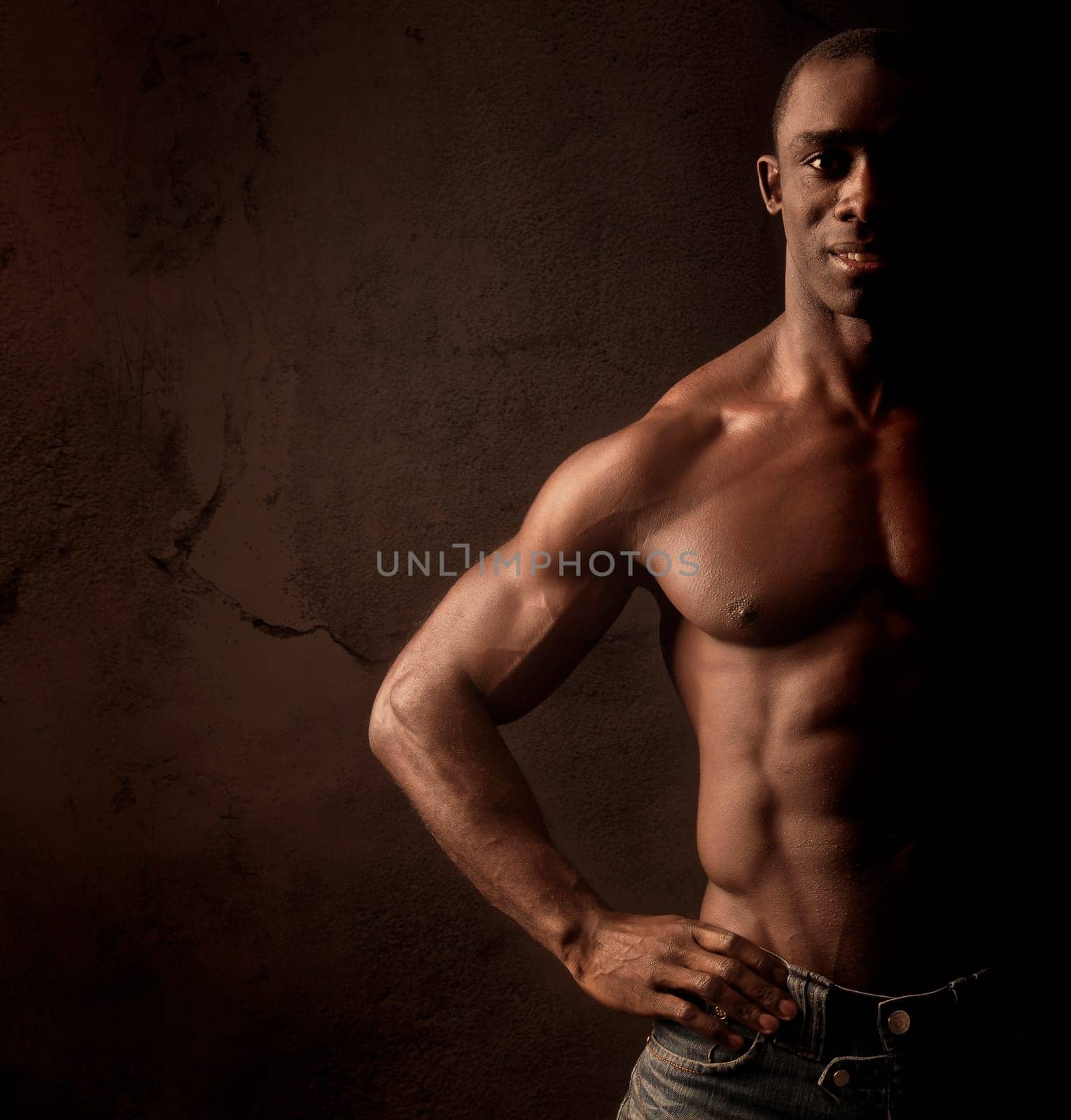 Beautiful and muscular black man in dark background