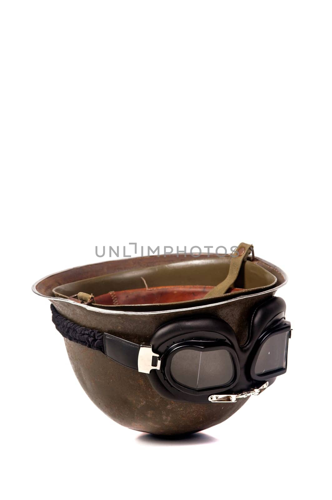 Old soldiers helmet with goggles isolated in white