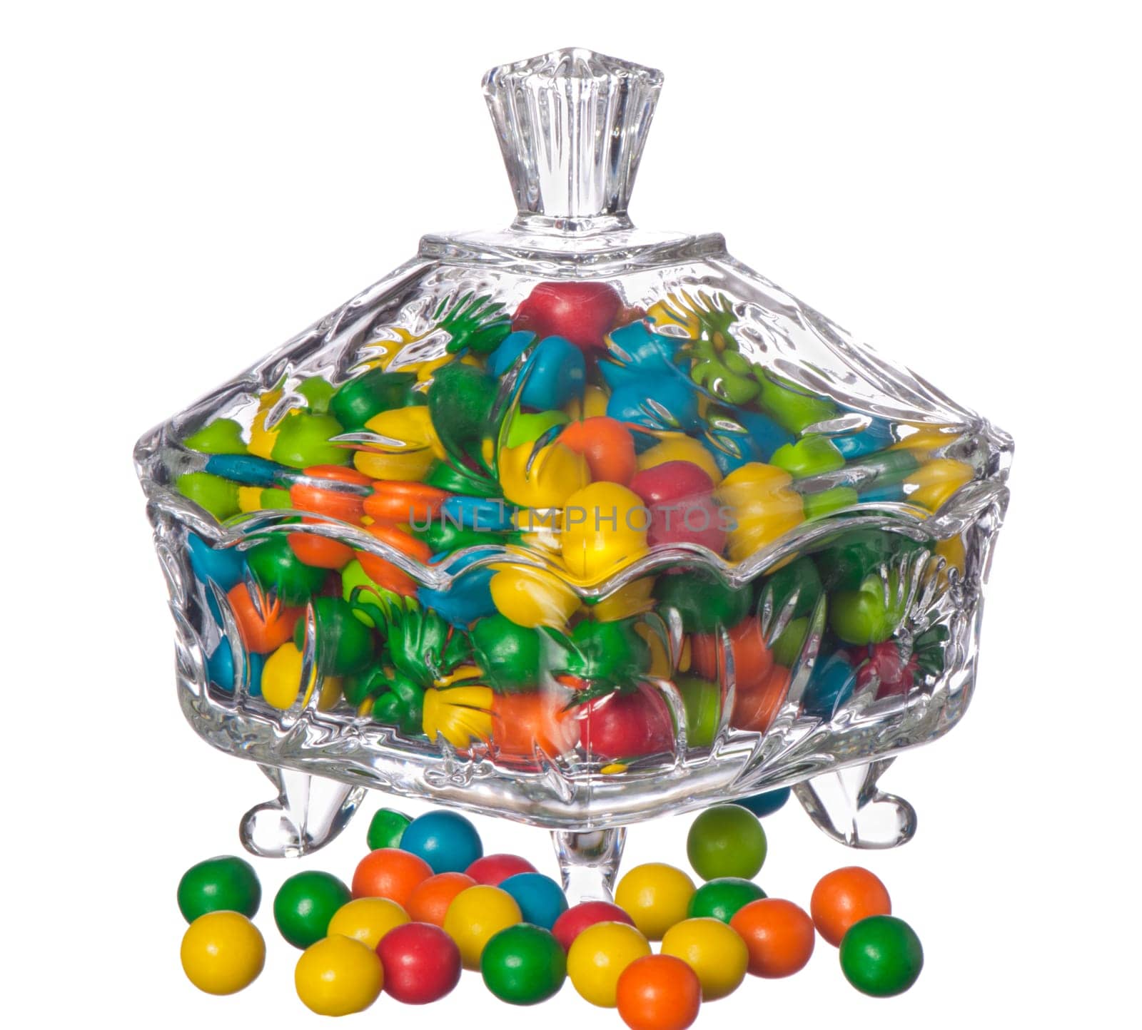 colored candy in a container of crystal on a white background