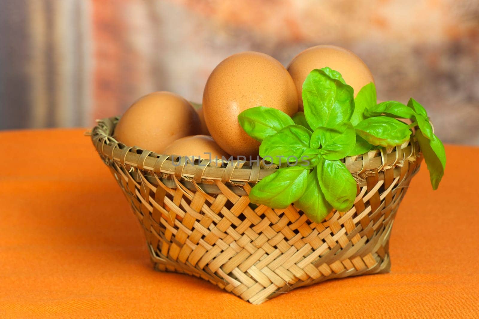 A basket of fresh eggs with orange background
