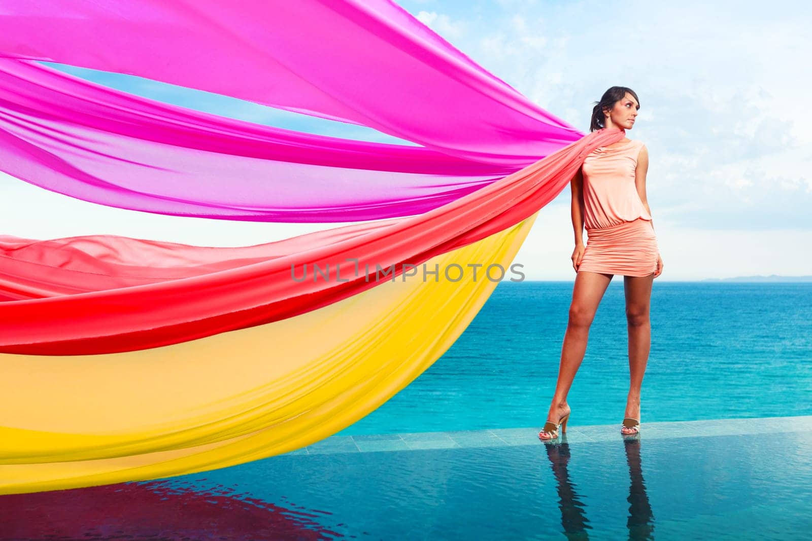 Woman with colorful scarfs on water