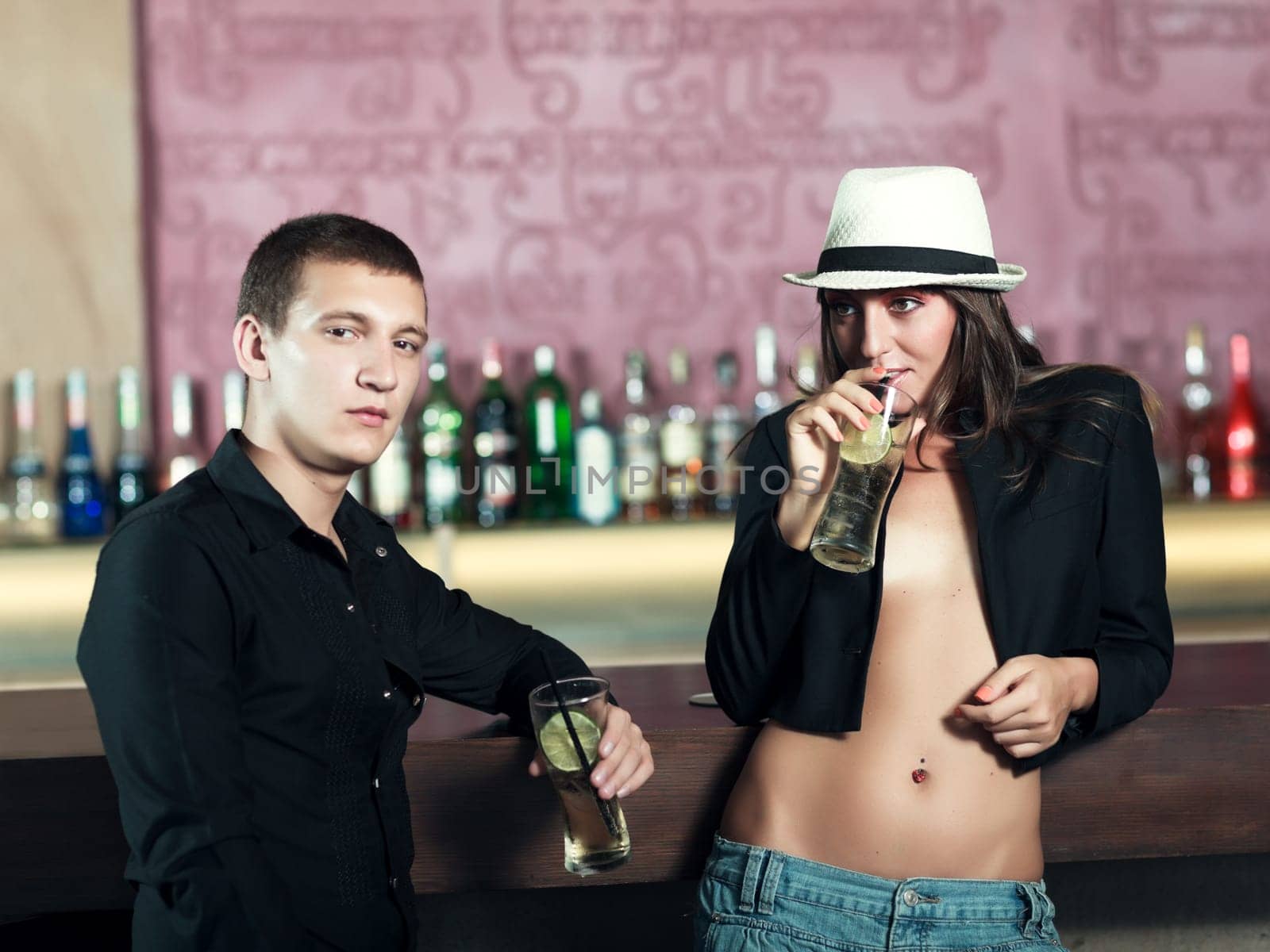 Fashion style photo of a couple in the bar