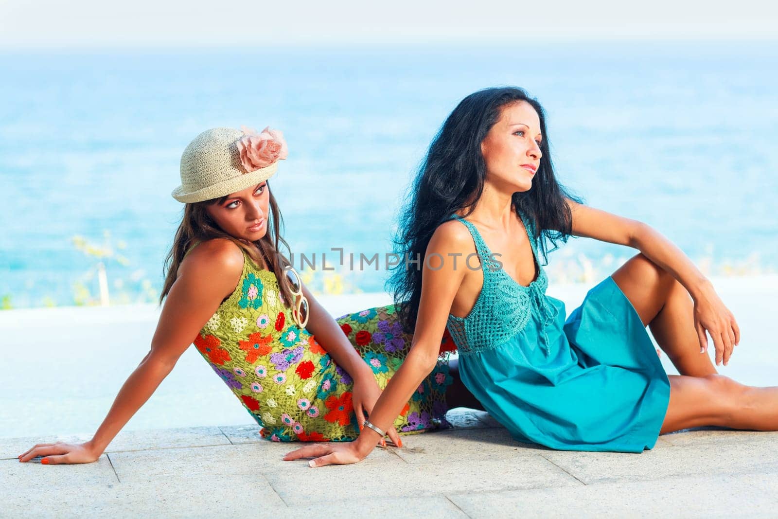 Two beautiful woman near the pool