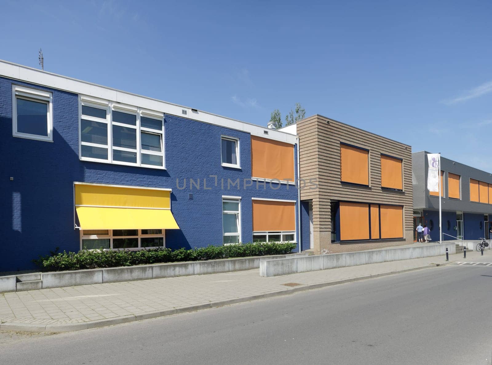 modern building with yellow and orange sunshades on a hot day