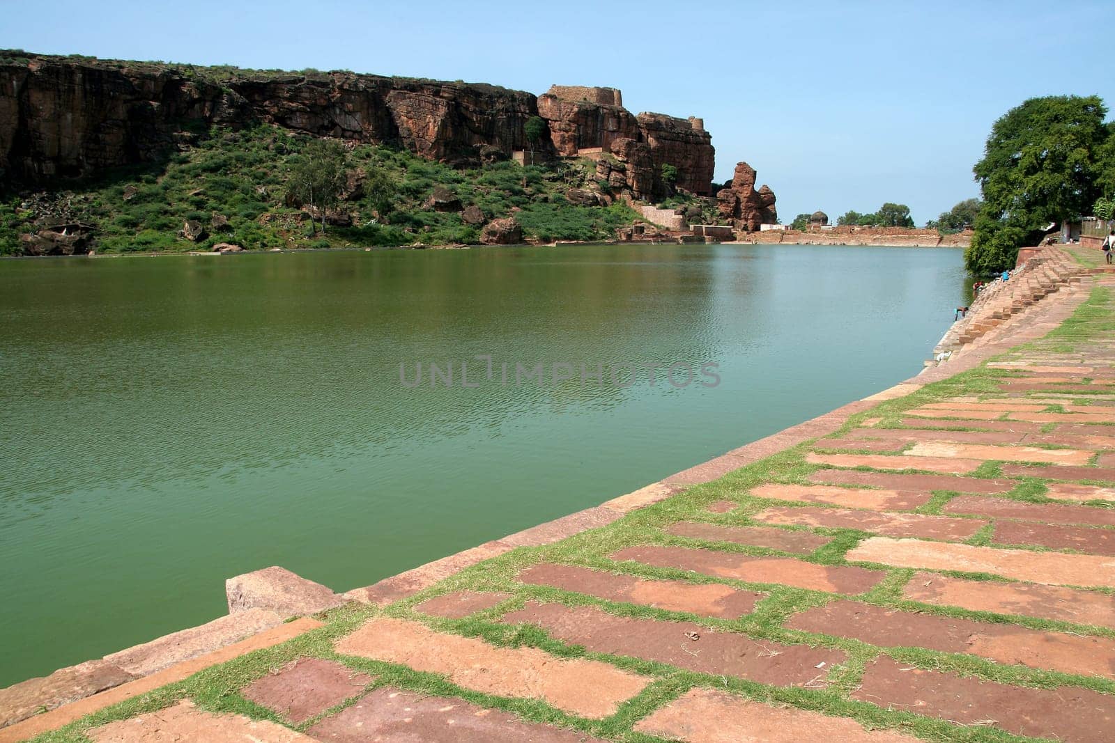 Lake Agusthya Teertha at Badami (with southern hill in background and dressed stone bund in foreground), Karnataka, India, Asia