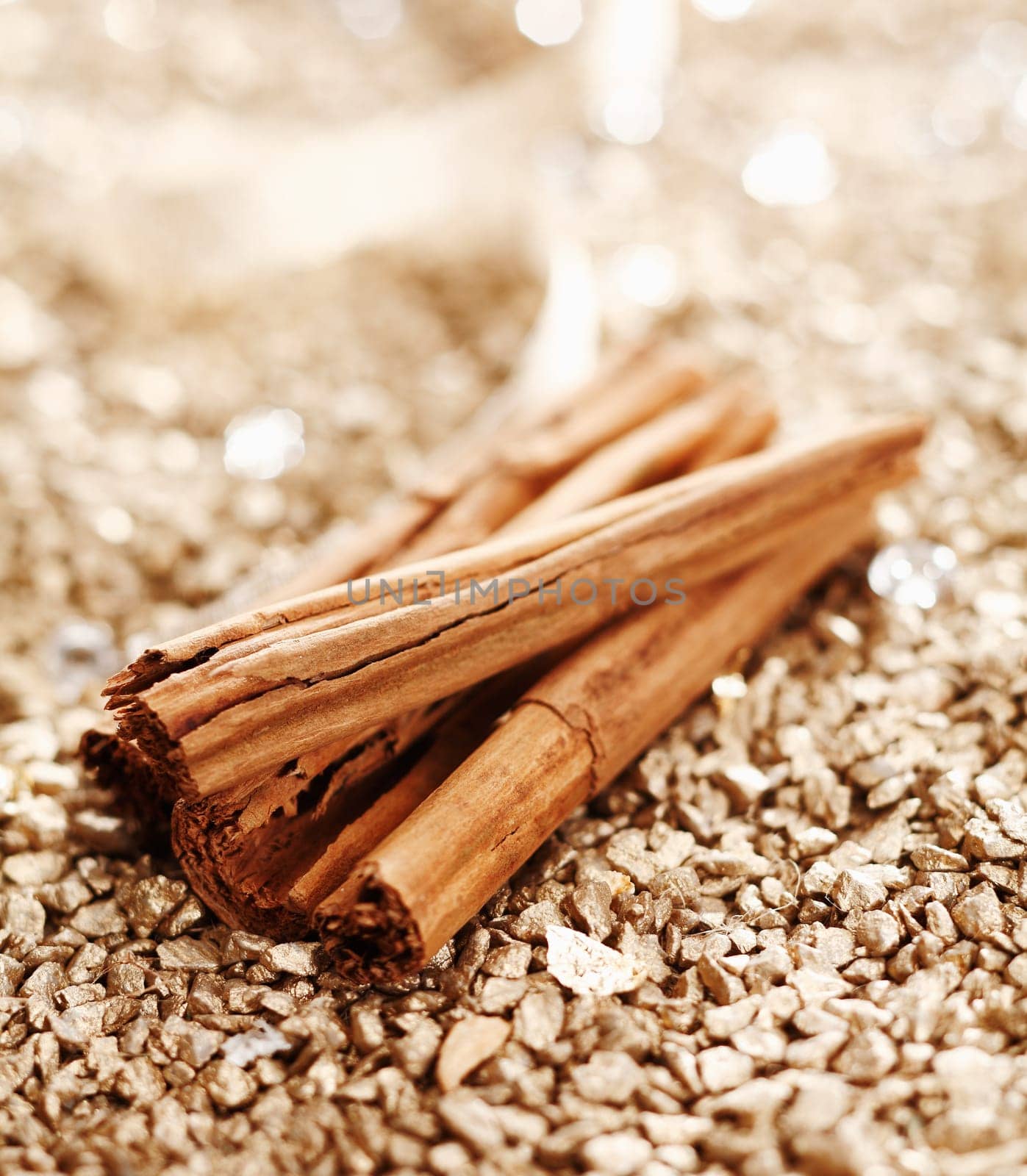 Some Cinnamon Sticks on a shiny golden background for wintery food concepts
