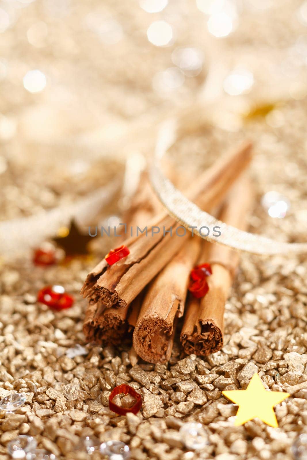 Cinnamon Sticks with a ribbon on a golden background for Christmas Concept.