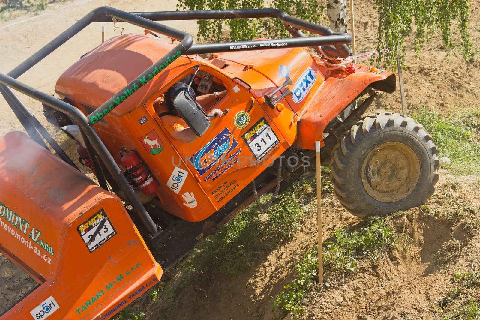 MOHELNICE, CZECH REPUBLIC - MAY 20. Unidentified orange truck climb difficult terrain in the "Grand Prix Truck Trial 2012"" on May 20, 2012 in the town of Mohelnice, Czech Republic."