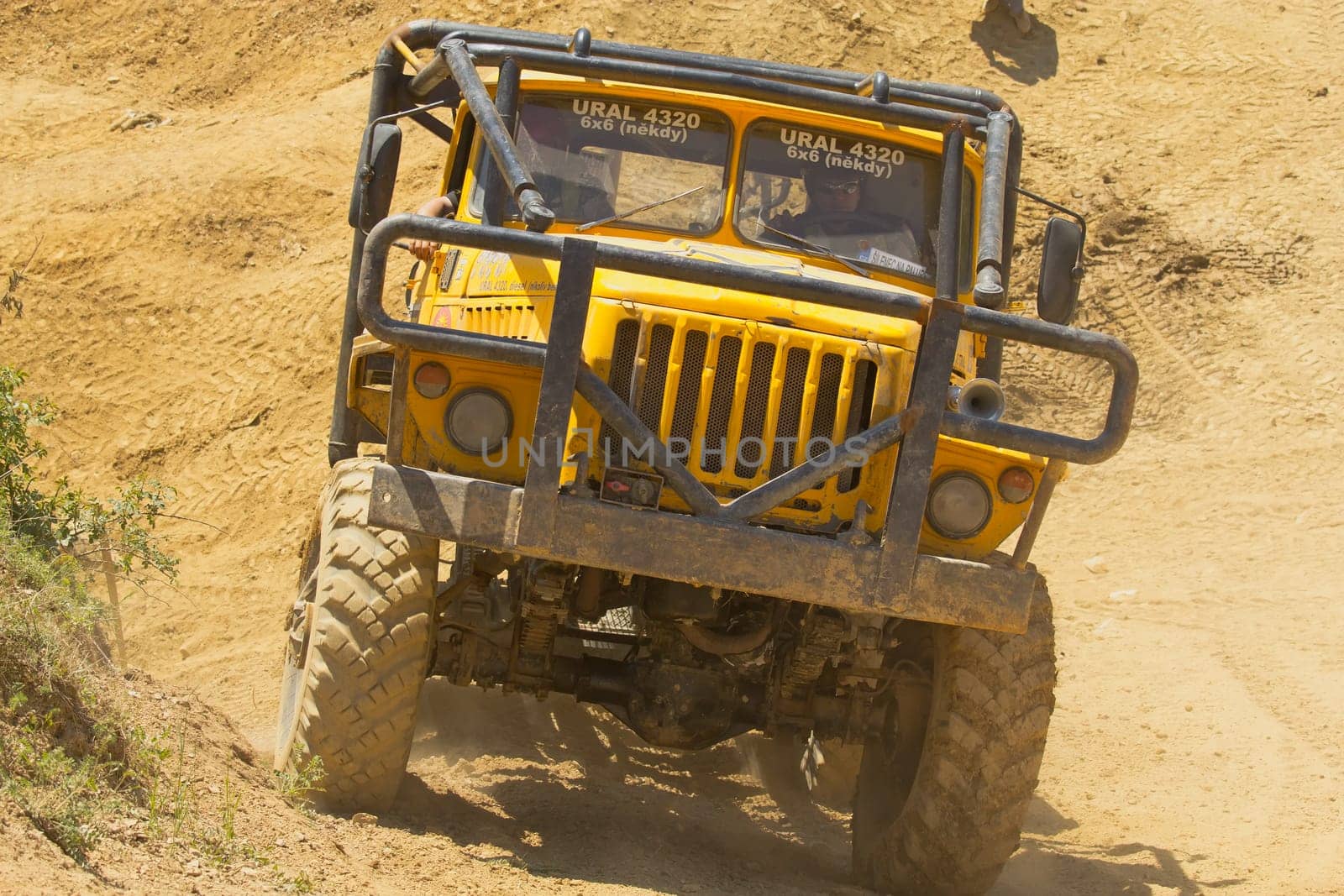 MOHELNICE, CZECH REPUBLIC - MAY 20. Unidentified racer at yellow truck leaves steep slope in the "Grand Prix Truck Trial 2012"" on May 20, 2012 in the town of Mohelnice, Czech Republic."