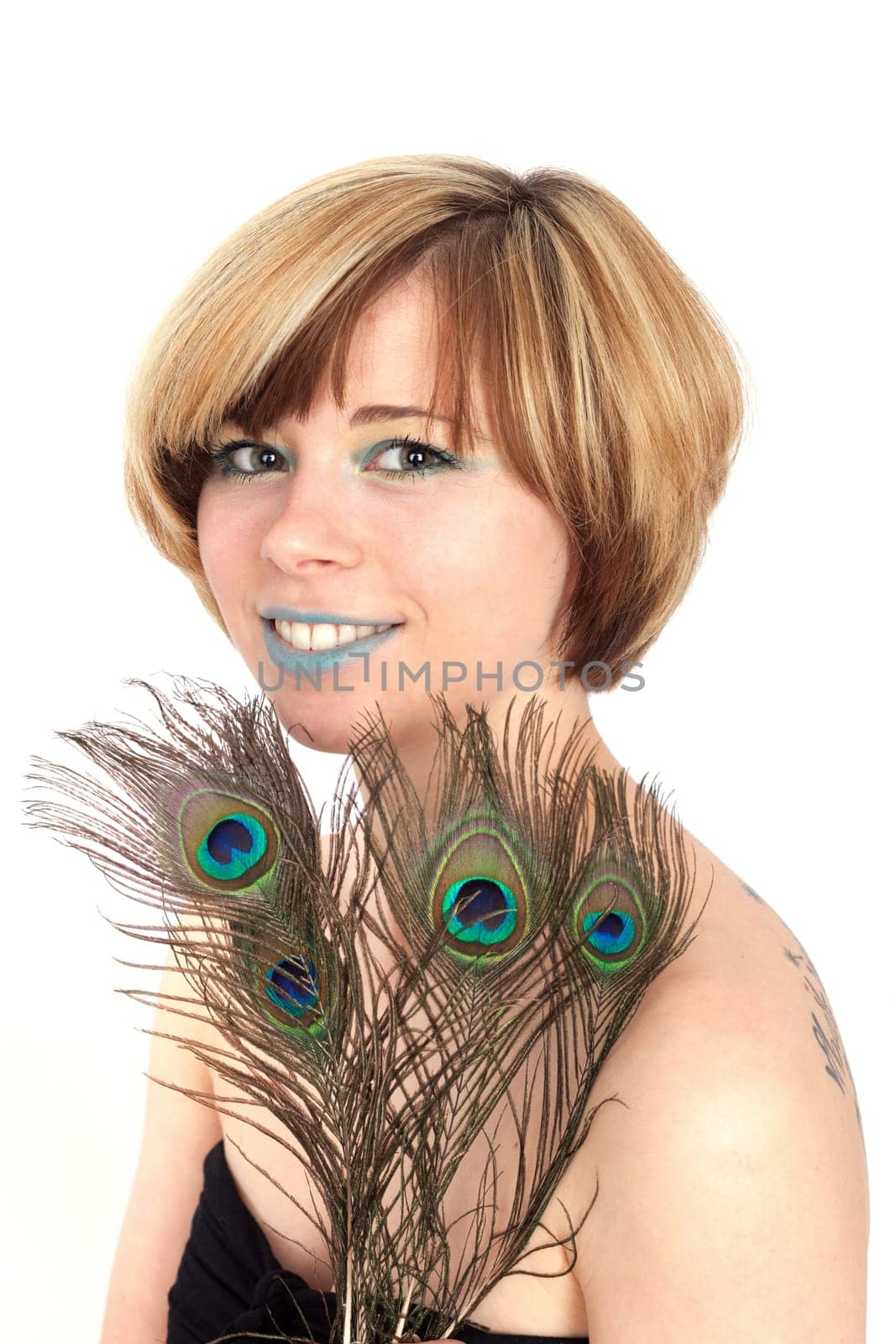 Young woman with peacock feather