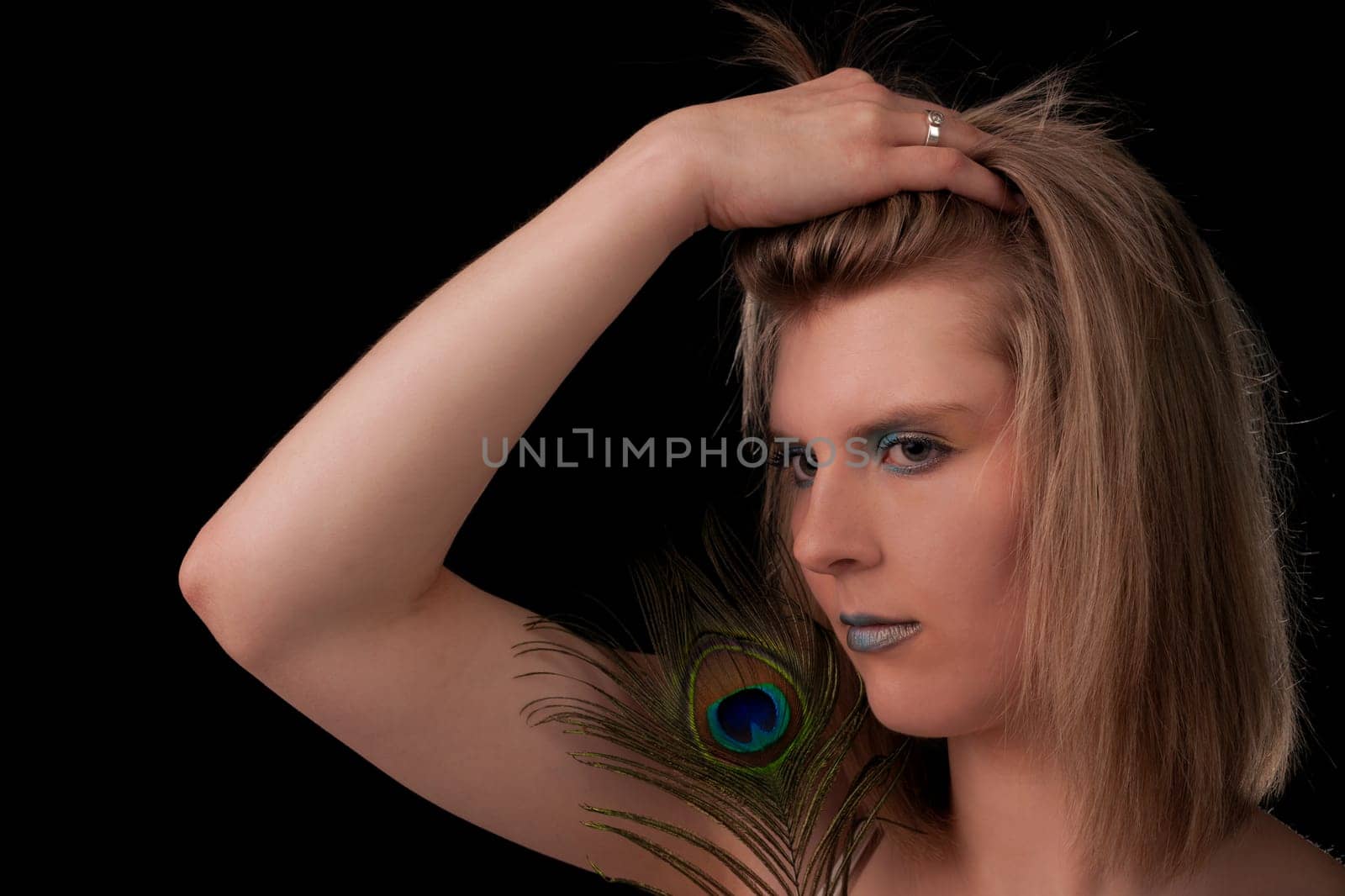 Young woman with peacock feather