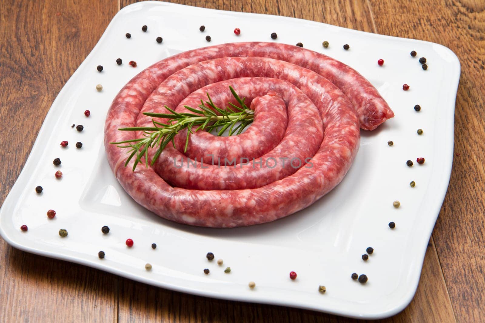 fresh raw sausage with rosemary and pepper