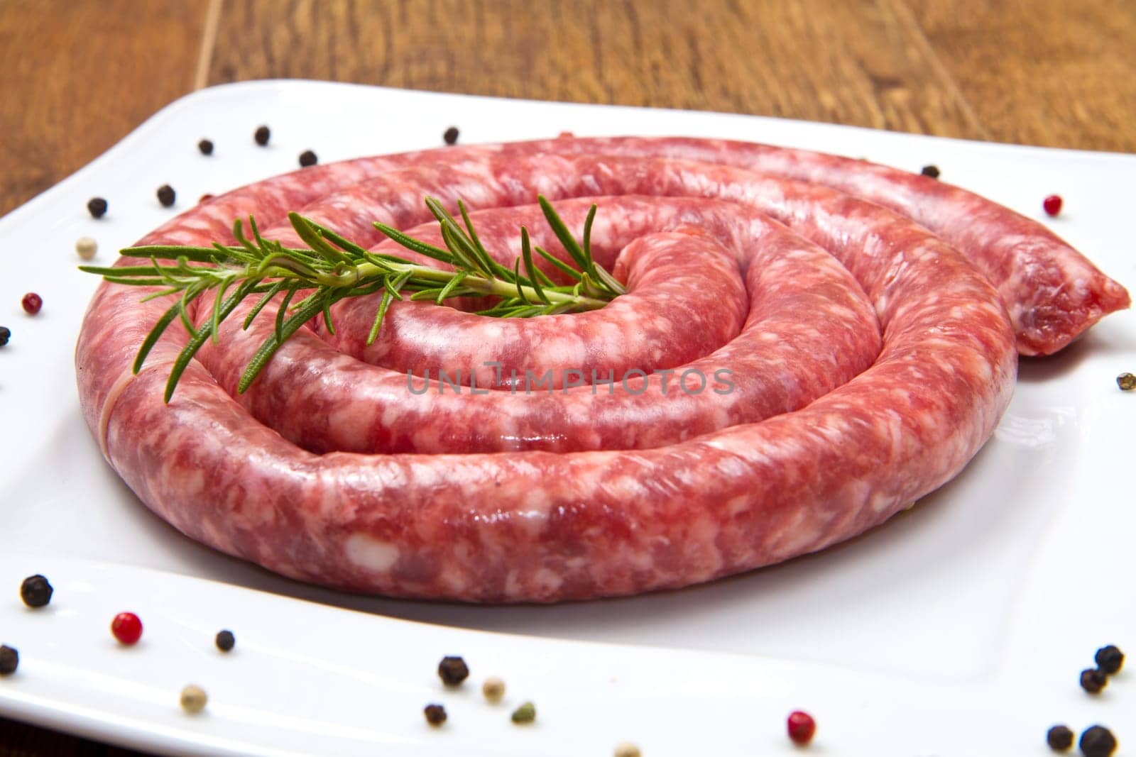 fresh raw sausage with rosemary and pepper