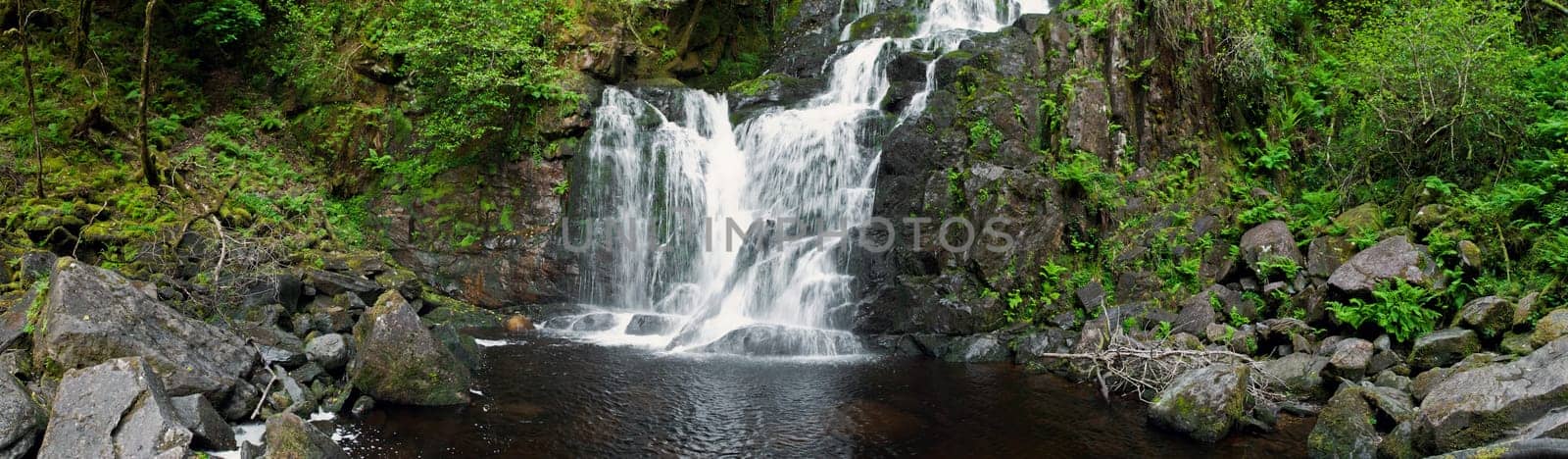 stunning Torc waterfall in the Killarney National Park, Ireland (panoramic picture with 180 angle view)