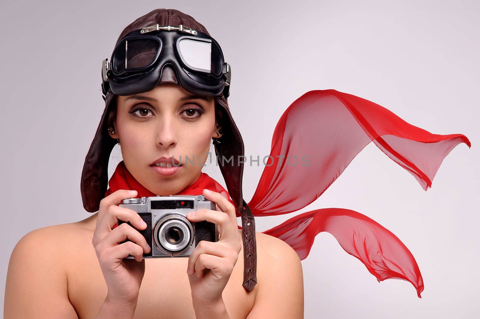 Beautiful girl with helmet and goggles and a camera