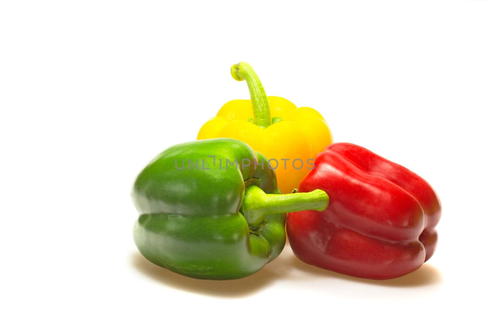 Green, red and yellow paprika (pepper) isolated on a white background