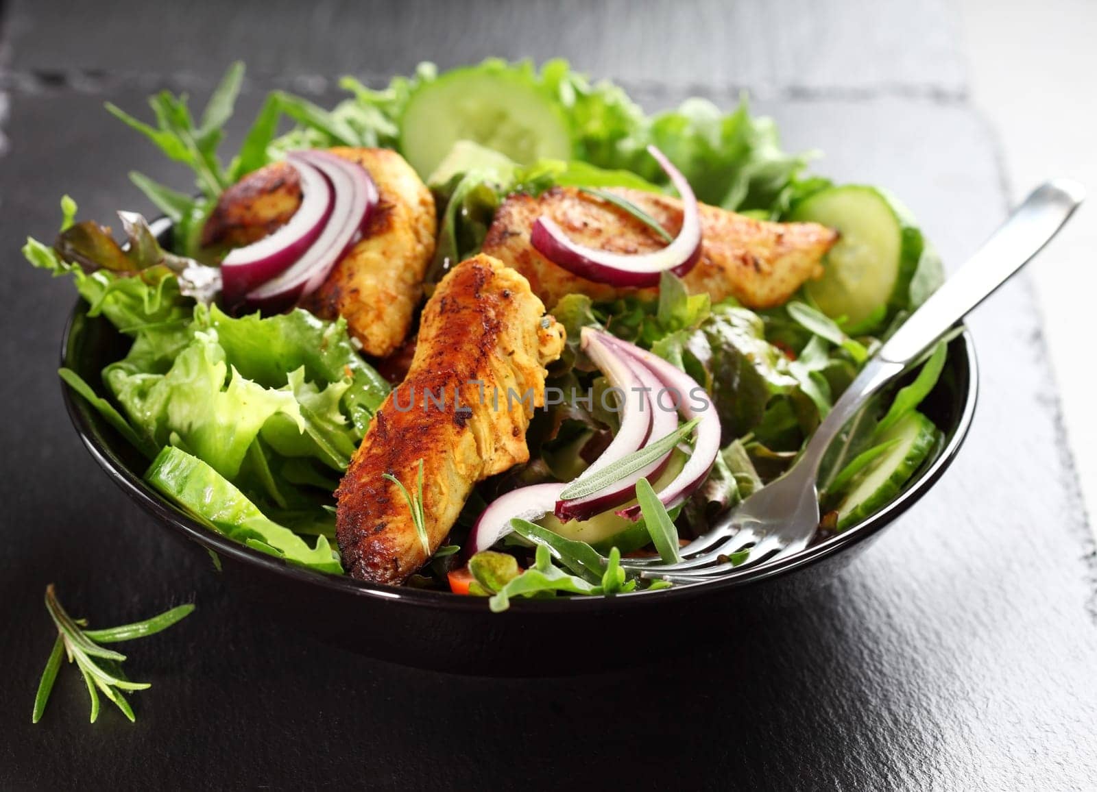 Salad with marinated Indian chicken breast stripes