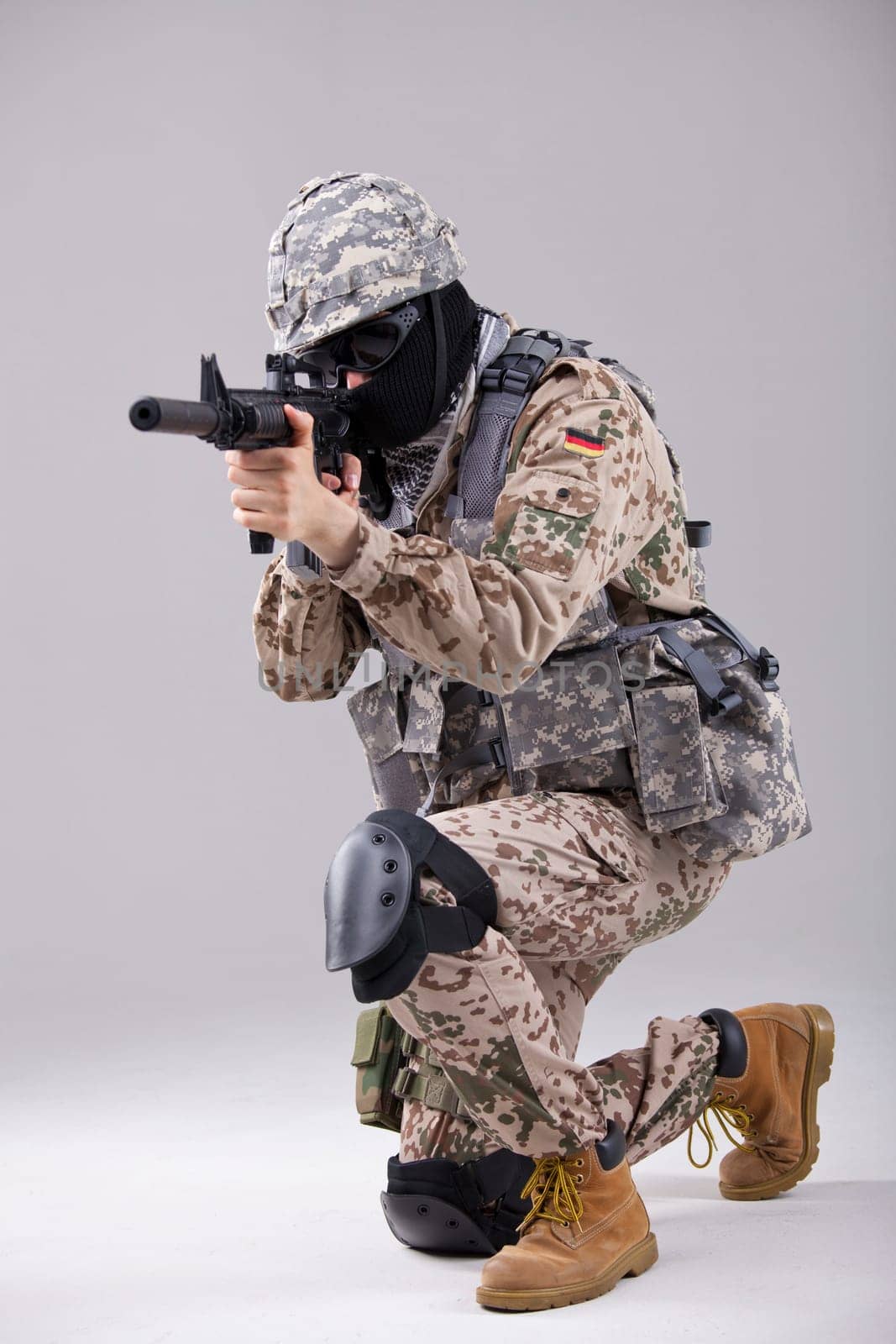 Soldier special forces with machine gun in a white studio
