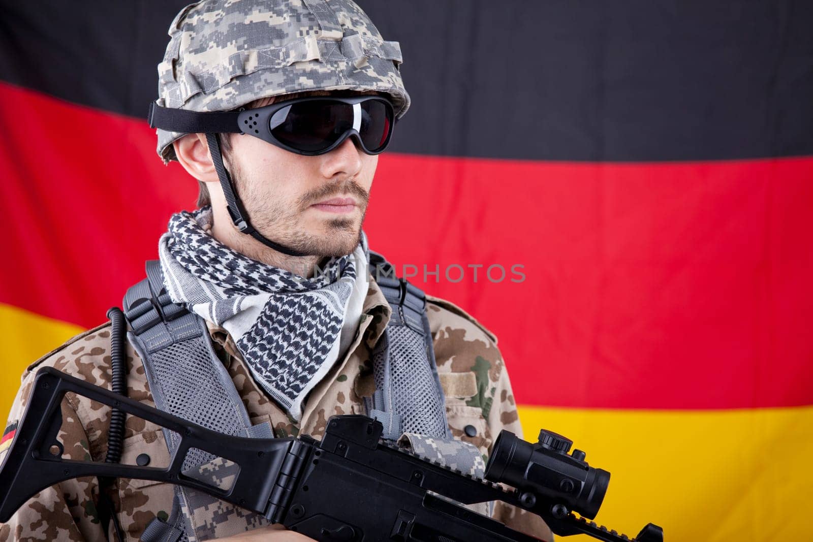 NATO Soldier with machine gun and helmet over german flag