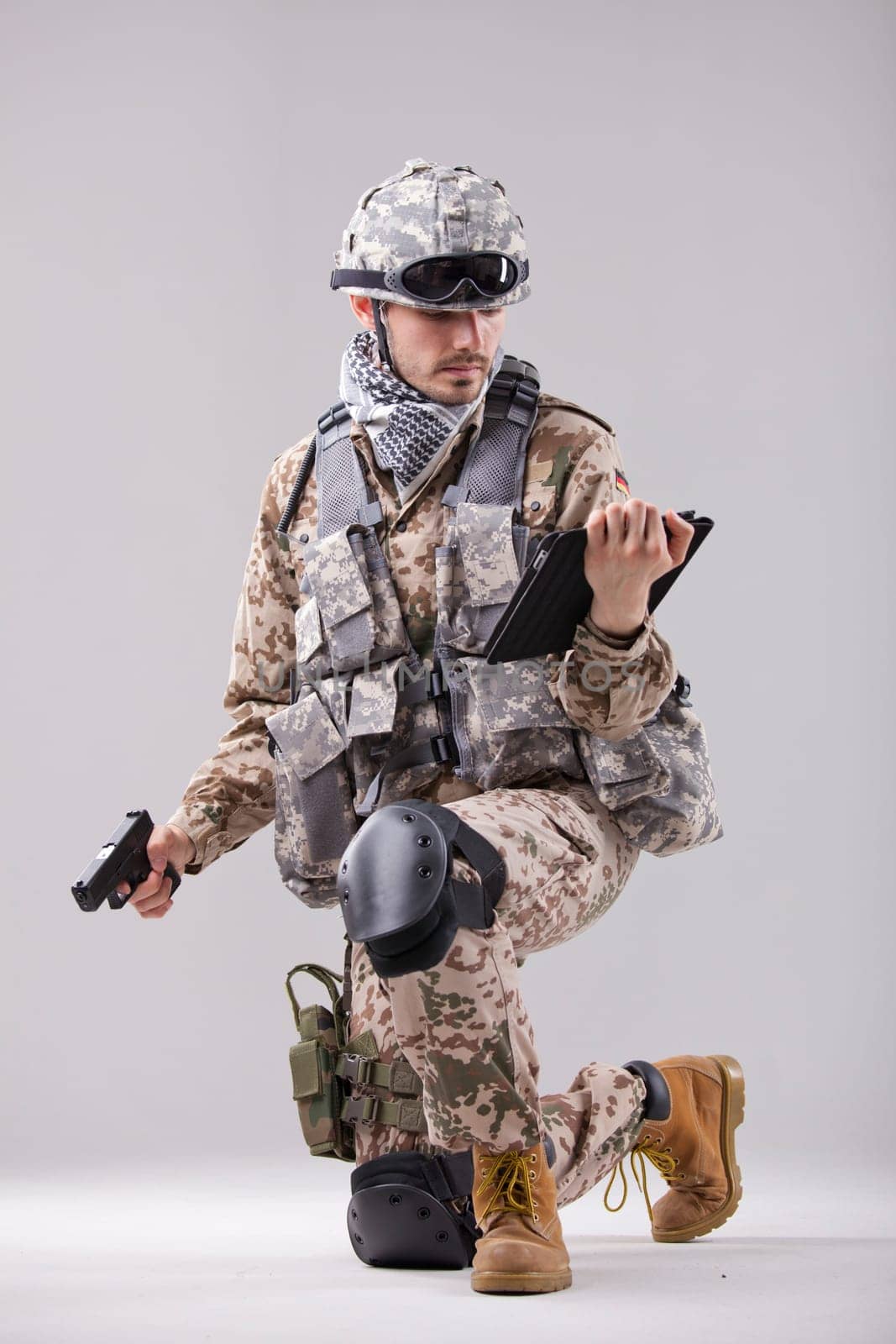 Modern soldier with handgun and tablet computer