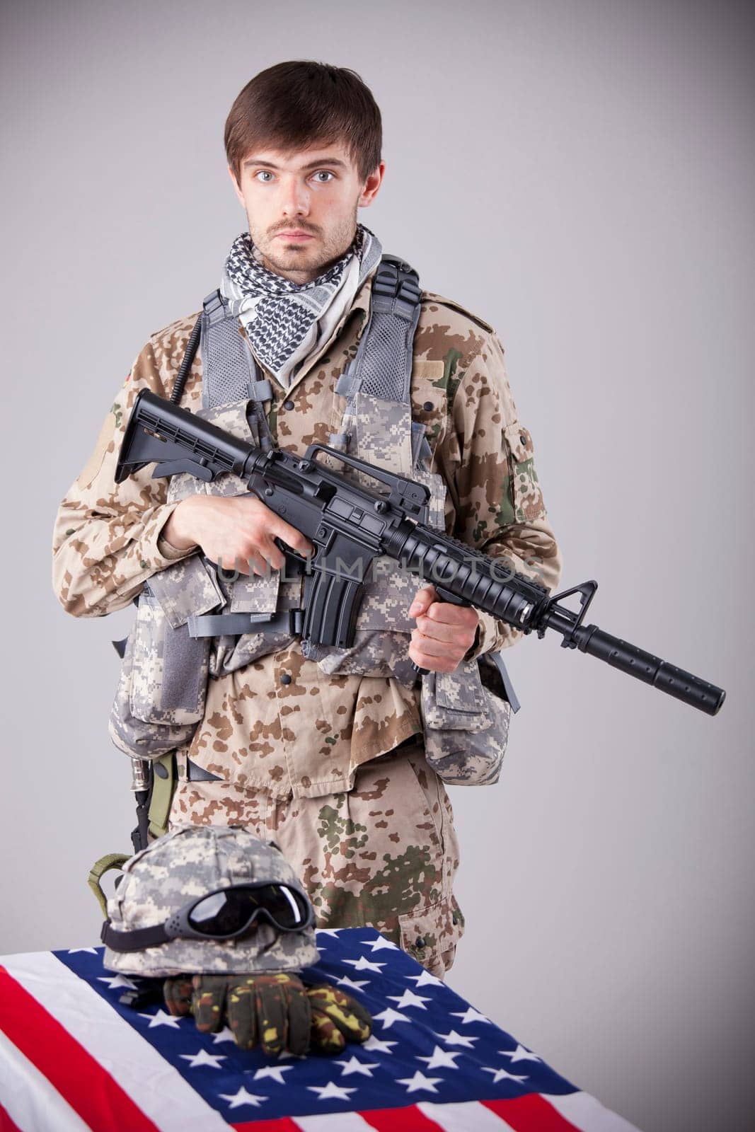 Fallen soldier memorial - sad soldier with machine gun on funeral