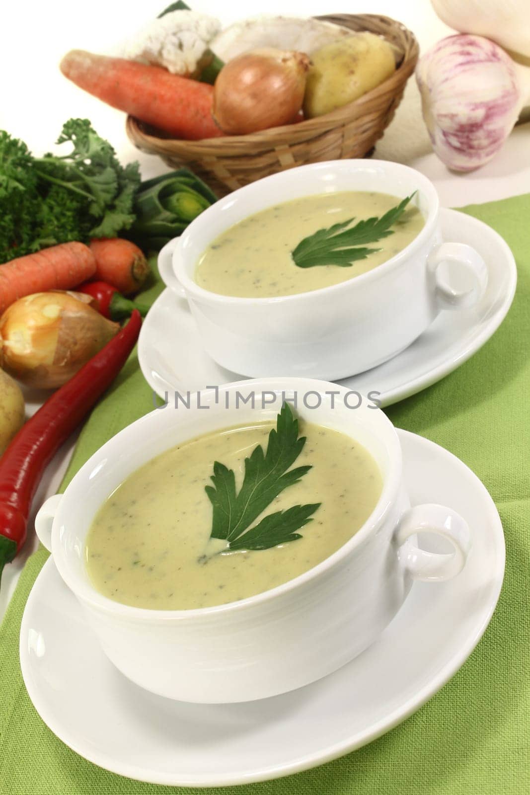 two cups of vegetable cream soup with parsley