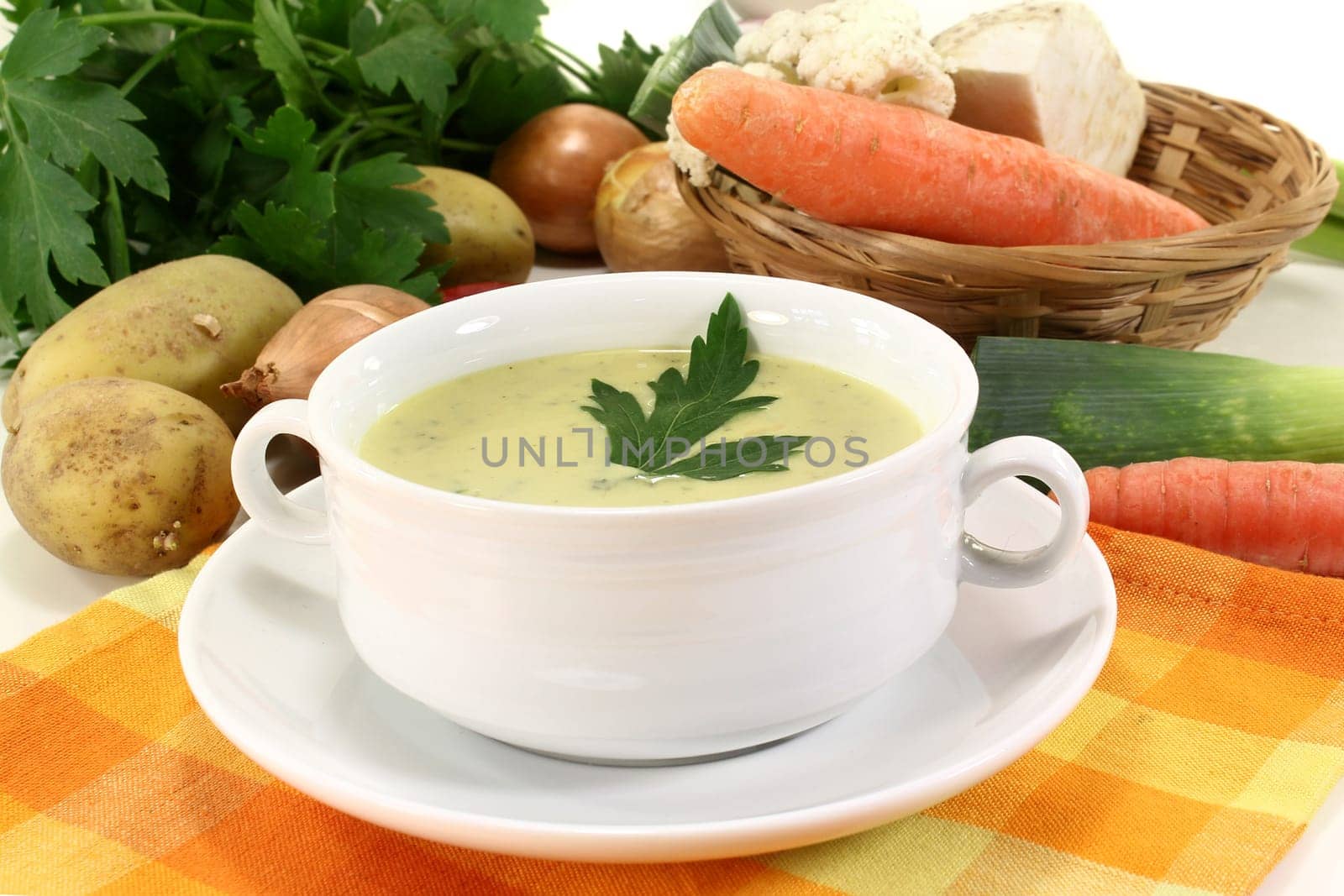 a cup of vegetable cream soup with parsley