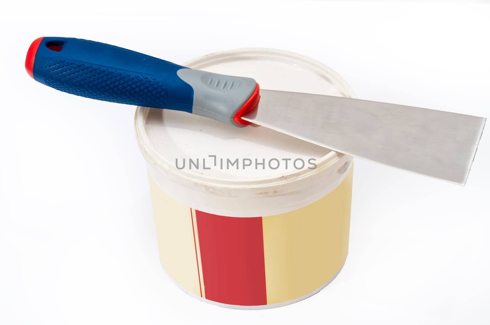 scraper and can of putty to repair cracks