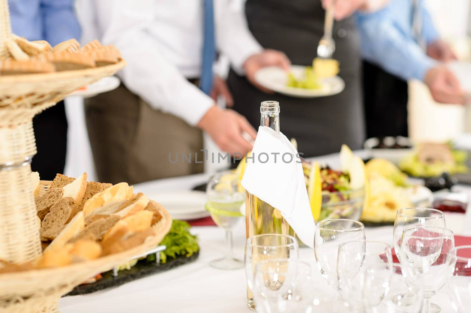 Business catering people serving themselves buffet at company meeting