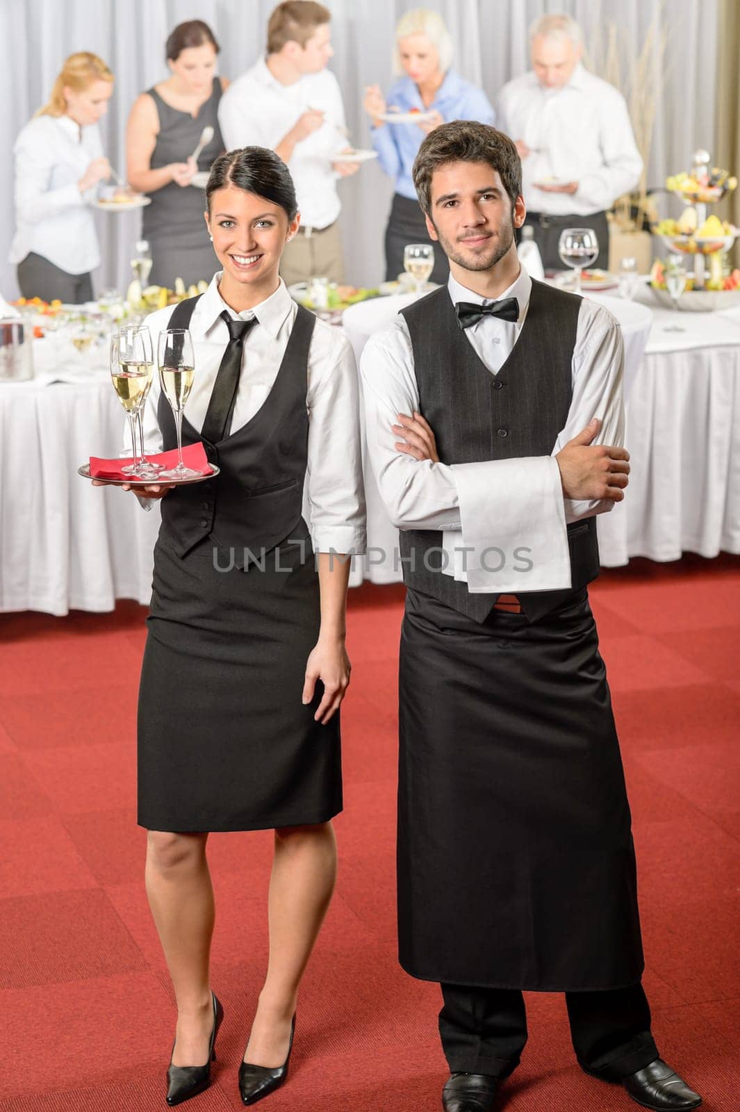 Catering service waiter, waitress business event serving drinks to guests