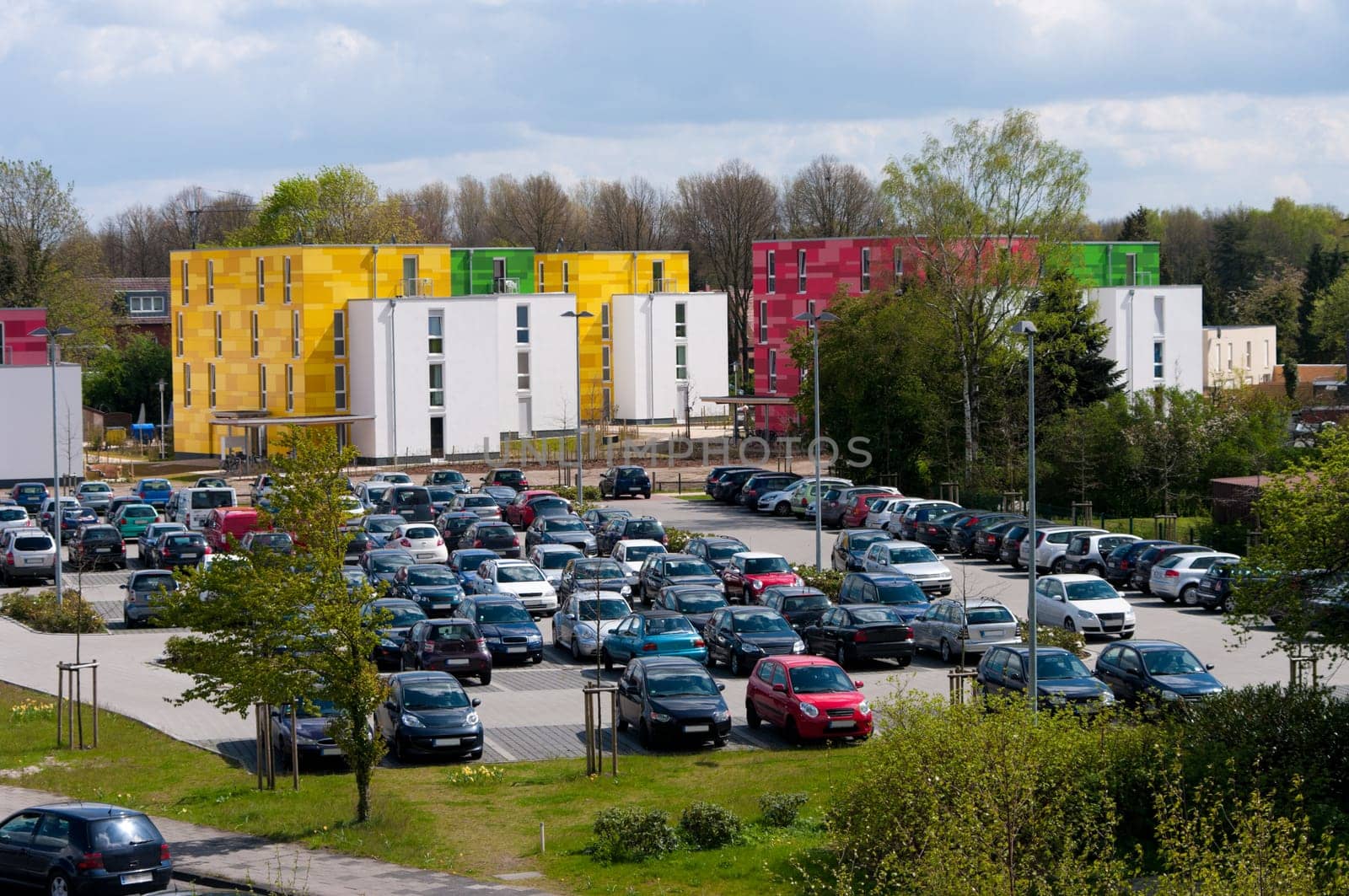 full parking place in front of some colorful apartments in Lingen, Germany