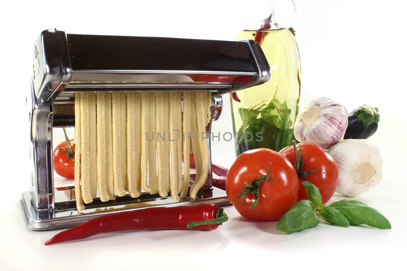a pasta machine with homemade ribbon noodles