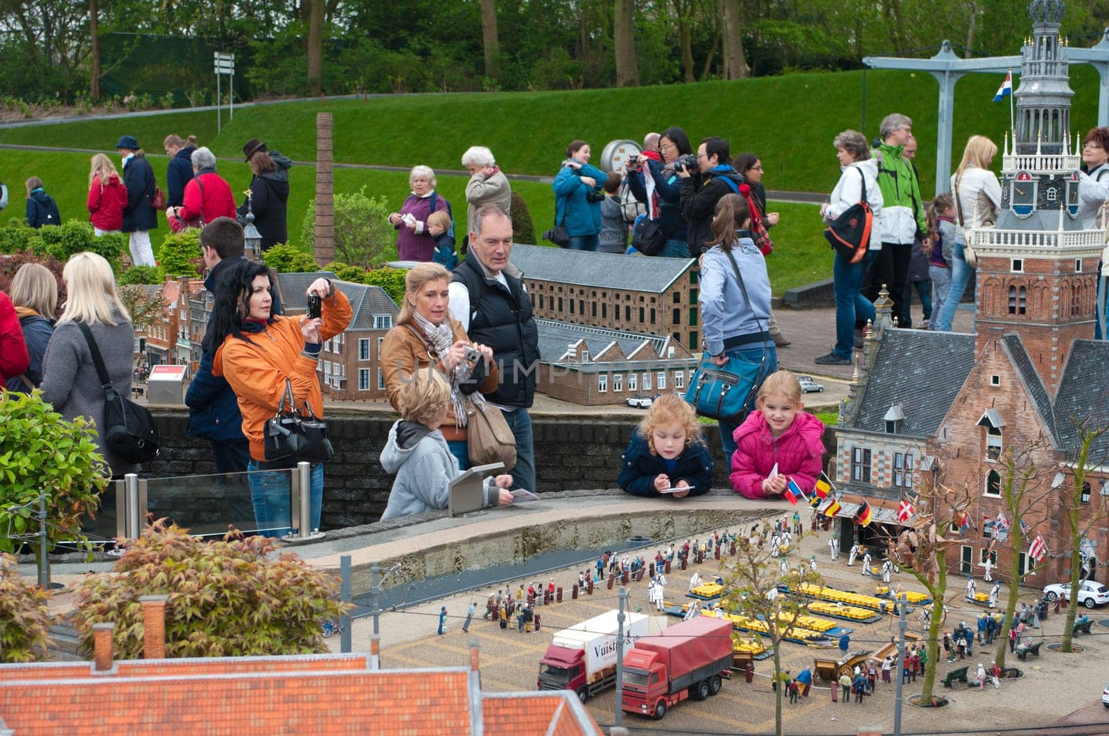 visitors enjoying the replicas of famous dutch buildings as a tourist attraction in Madurodam park in The Hague, Netherlands.