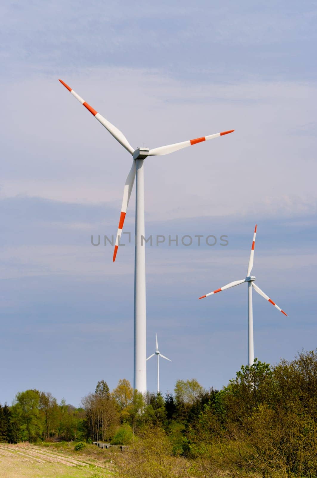 several windmills against a blue sky