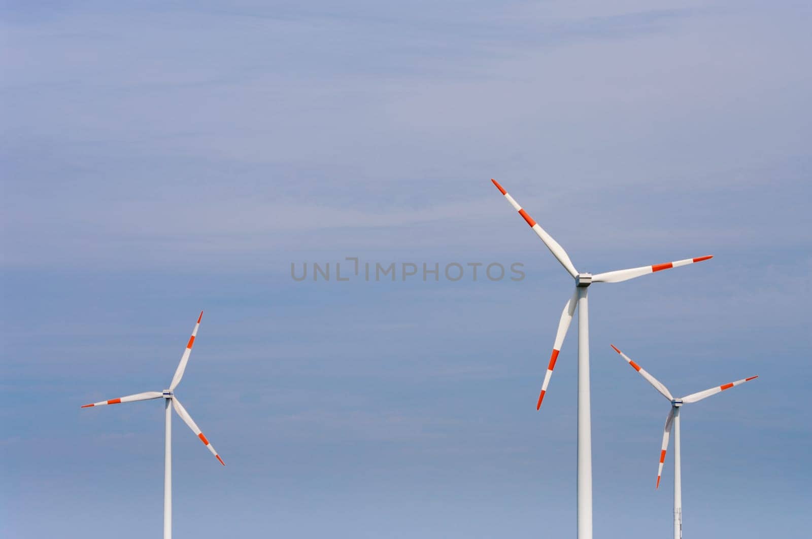 several windmills against a blue sky