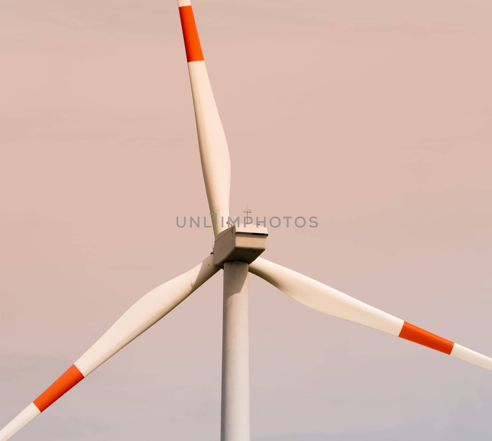 closeup of a windmill with red and white blades