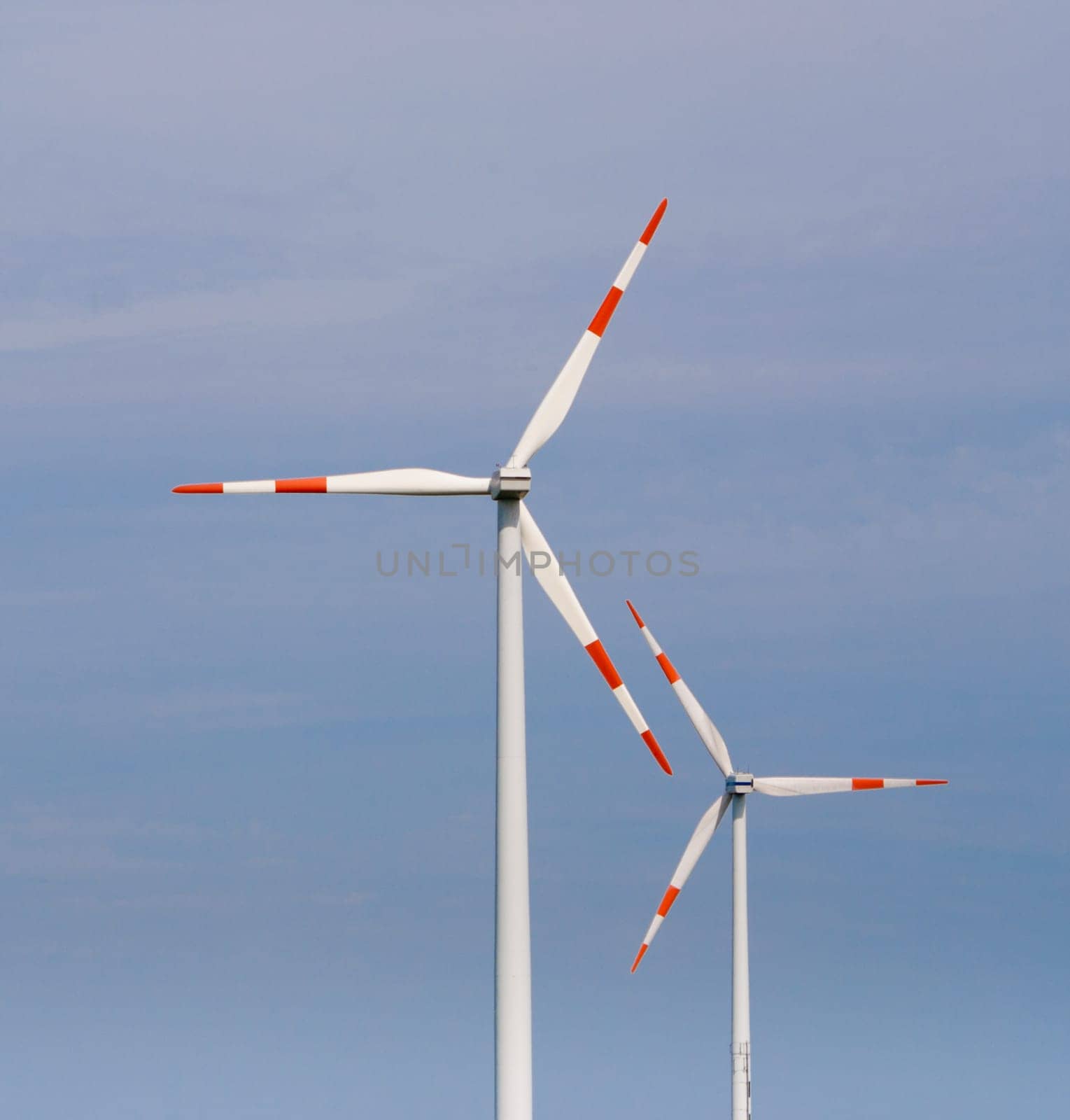 two windmills against a blue sky