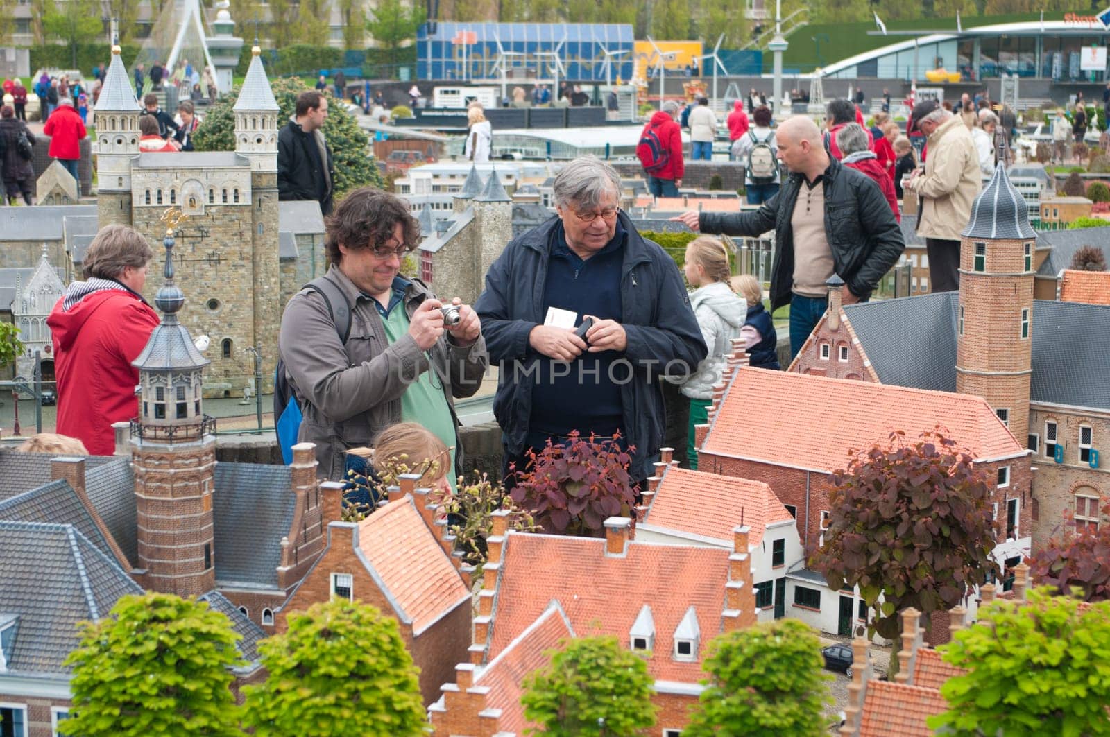 visitors enjoying the replicas of famous dutch buildings as a tourist attraction in Madurodam park in The Hague, Netherlands.