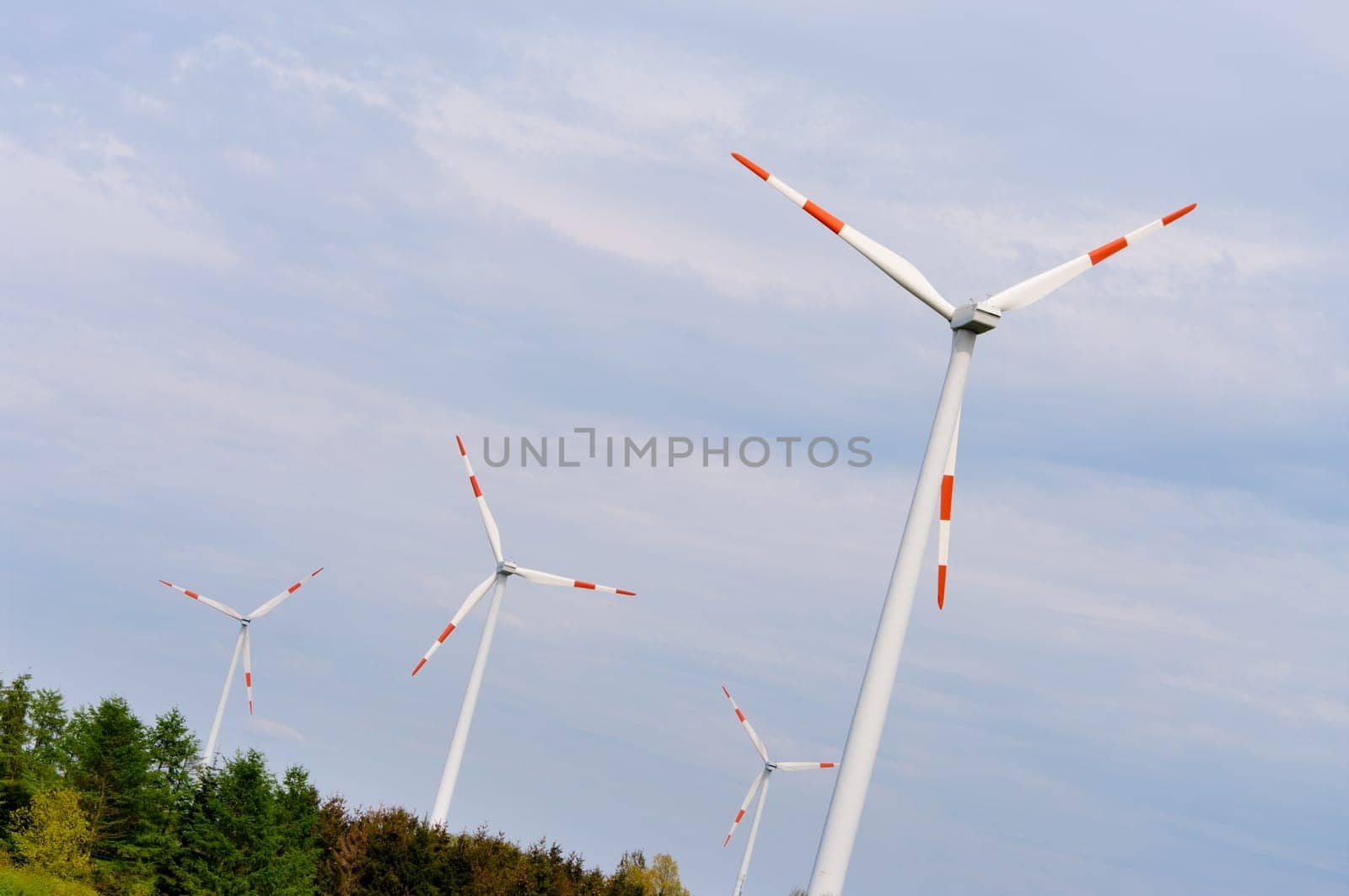 several windmills against a blue sky