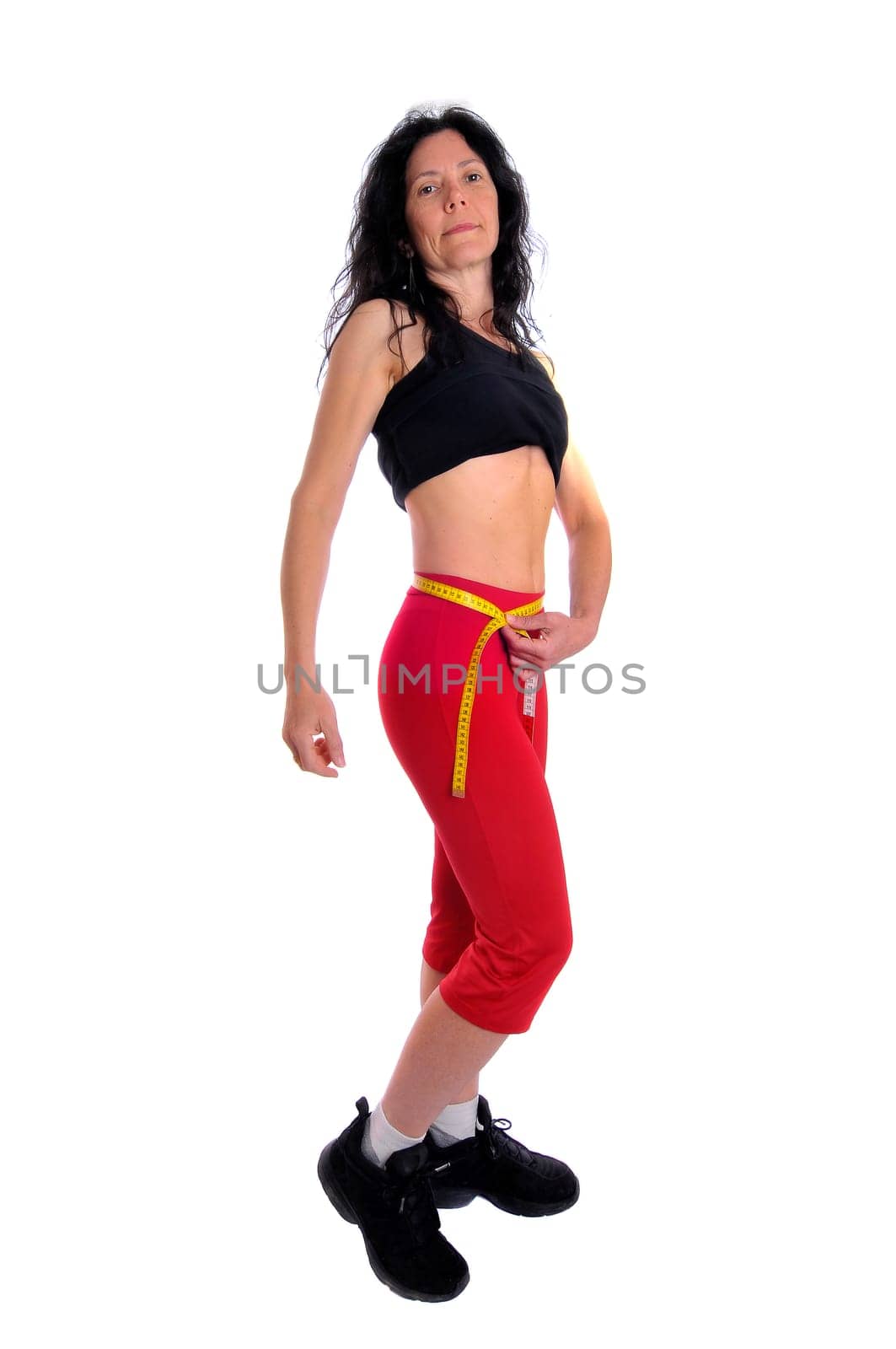 Mature fit woman with measuring tape isolated in white