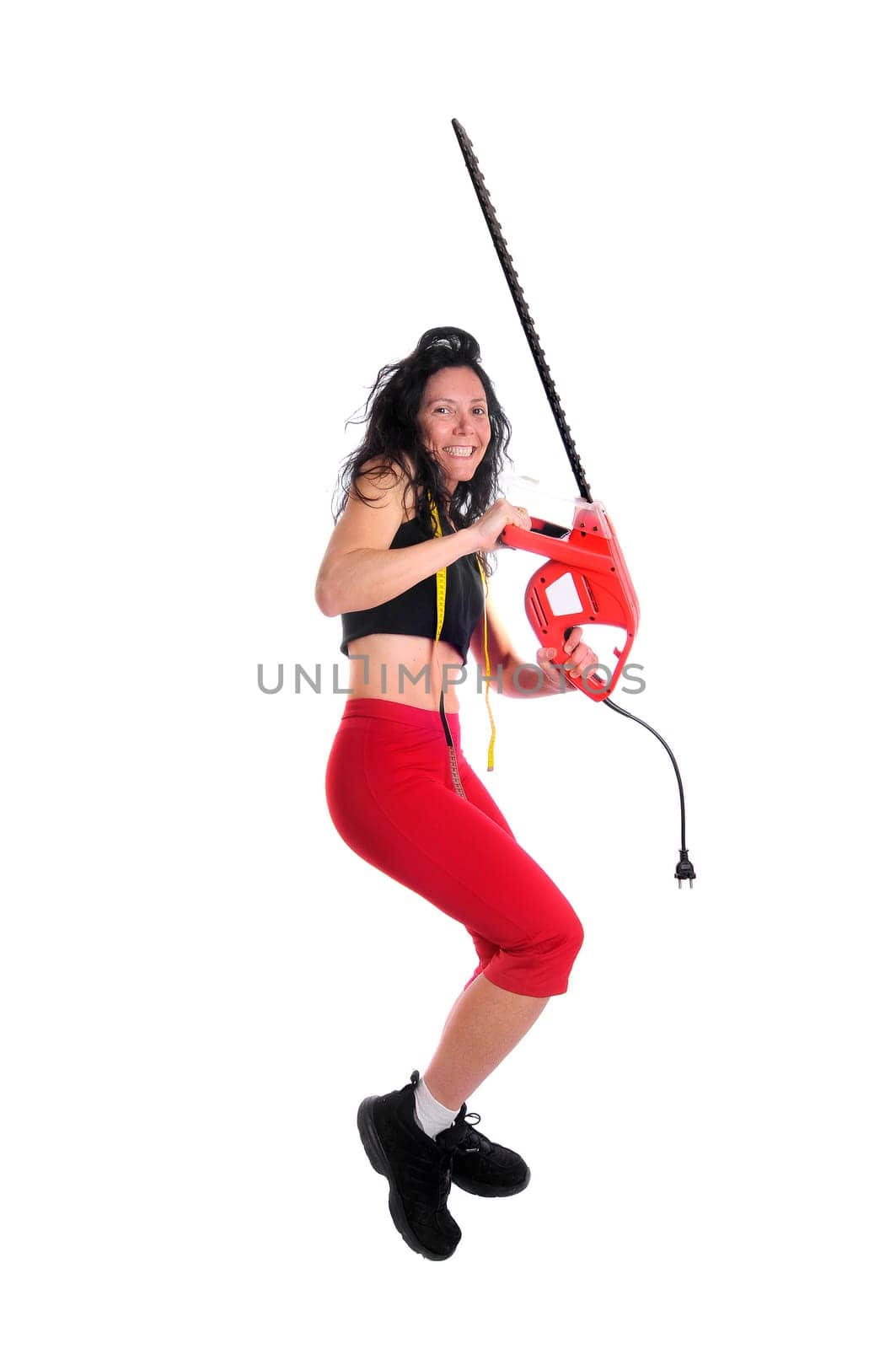 Mature fit woman with measuring tape and saw isolated in white