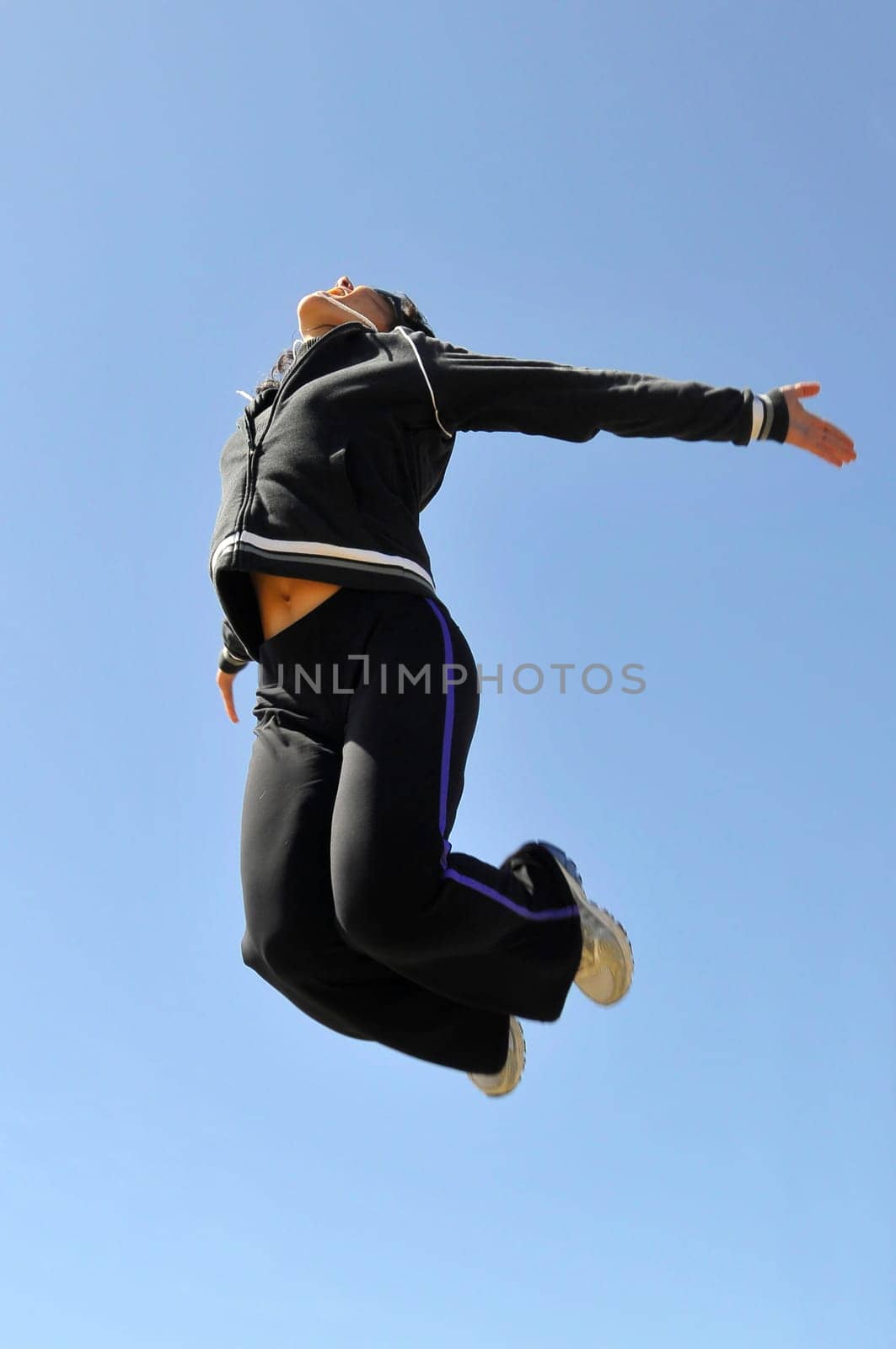 Woman jumping high outdoors