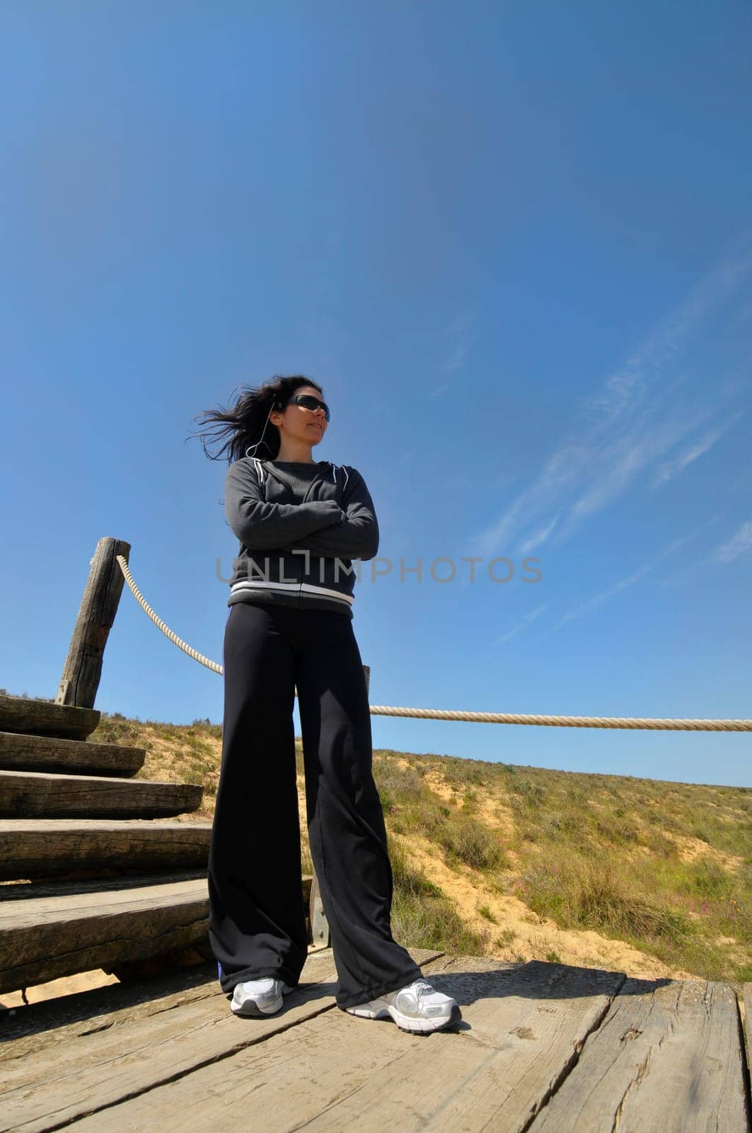 Woman posing in a wooden bride near the beach